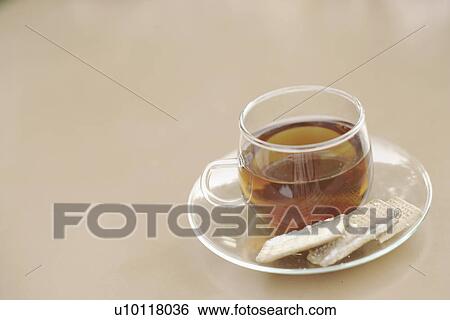 Close-up of a cup of black tea with cookies View Large Photo Image Stock Photograph - Close-up of a cup of black tea with cookies. Fotosearch