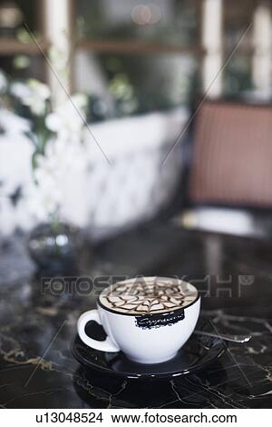 High angle view of a coffee cup with a spoon and a saucer View Large Photo Image Picture - High angle view of a coffee cup with a spoon and a saucer. Fotosearch