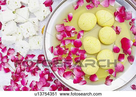 High angle view of a dish of Indian sweets with flower petals around it View Large Photo Image Stock Image - High angle view of a dish of Indian sweets with flower petals around it. Fotosearch