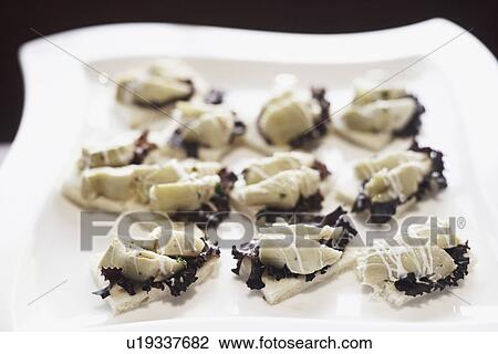 Stock Image - High angle view of appetizers on a tray. Fotosearch