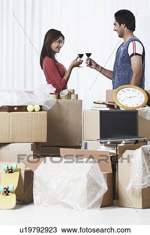 Side profile of a young couple raising a toast View Large Photo Image Stock Image - Side profile of a young couple raising a toast. Fotosearch