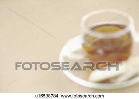 Picture - Close-up of a cup of black tea with cookies. Fotosearch