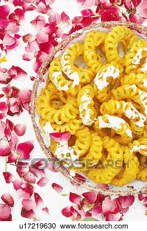 Close-up of a dish of Indian sweets with flower petals around it View Large Photo Image Stock Image - Close-up of a dish of Indian sweets with flower petals around it. Fotosearch