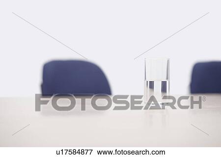 Close-up of a glass of water on a conference table View Large Photo Image Stock Photo - Close-up of a glass of water on a conference table. Fotosearch