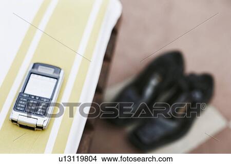 Close-up of a mobile phone on a table View Large Photo Image Picture - Close-up of a mobile phone on a table. Fotosearch