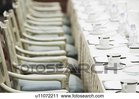 Close-up of chairs at a table View Large Photo Image Stock Image - Close-up of chairs at a table. Fotosearch