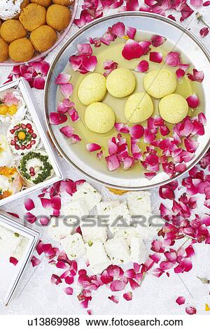 High angle view of a dish of Indian sweets with flower petals around it View Large Photo Image Stock Photo - High angle view of a dish of Indian sweets with flower petals around it. Fotosearch