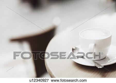 Stock Photo - High angle view of a teacup with a saucer and a spoon. Fotosearch
