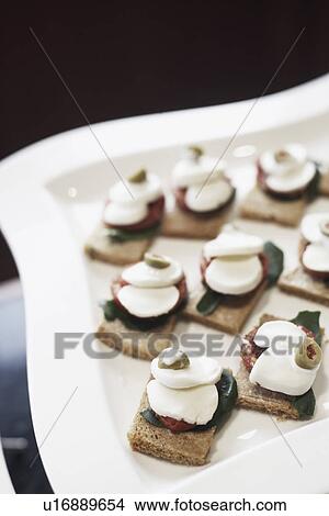 Picture - High angle view of appetizers on a tray. Fotosearch