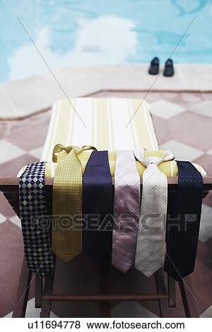 High angle view of ties on a lounge chair at the poolside View Large Photo Image Stock Photo - High angle view of ties on a lounge chair at the poolside. Fotosearch