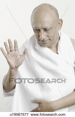 Stock Photo - Close-up of a mature man giving blessings. Fotosearch