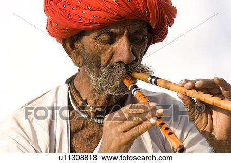Close-up of a senior man playing two flutes, Pushkar, Rajasthan, India View Large Photo Image Stock Photo - Close-up of a senior man playing two flutes, Pushkar, Rajasthan, India. Fotosearch
