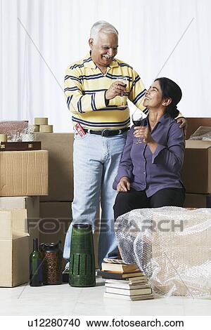 Mature couple raising a toast View Large Photo Image Stock Image - Mature couple raising a toast. Fotosearch