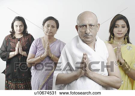 Stock Image - Mature man and three women in a prayer position. Fotosearch