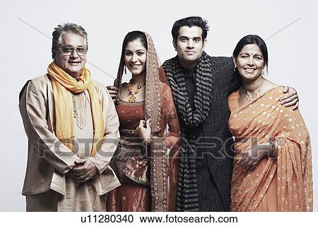 Newlywed couple standing with their parents View Large Photo Image Stock Image - Newlywed couple standing with their parents. Fotosearch