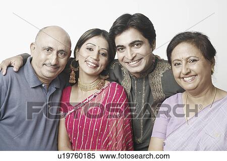 Stock Photography - Portrait of a mature couple and a mid adult couple smiling. Fotosearch