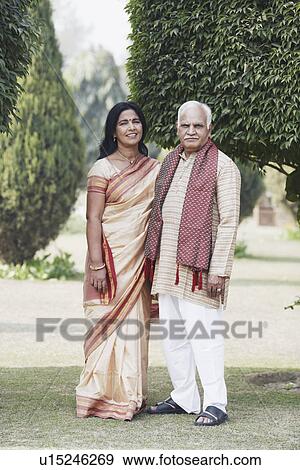 Portrait of a mature couple standing in the garden View Large Photo Image Stock Photo - Portrait of a mature couple standing in the garden. Fotosearch