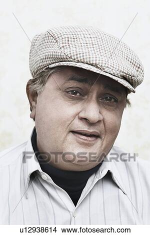 Picture - Portrait of a mature man wearing a cap. Fotosearch