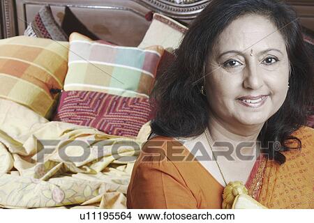 Portrait of a mature woman smiling View Large Photo Image Picture - Portrait of a mature woman smiling. Fotosearch