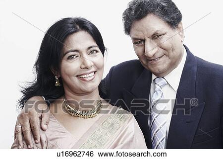 Portrait of a senior man and a mature woman with his arm around smiling View Large Photo Image Stock Photograph - Portrait of a senior man and a mature woman with his arm around smiling. Fotosearch