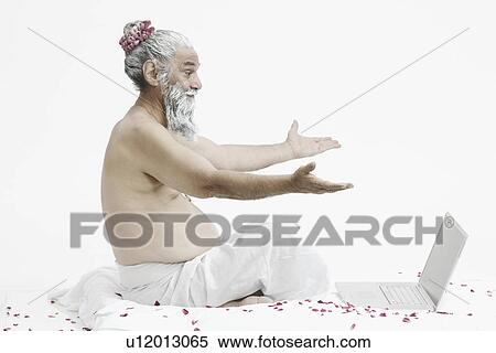 Side profile of a priest sitting in front of a laptop View Large Photo Image Stock Photography - Side profile of a priest sitting in front of a laptop. Fotosearch