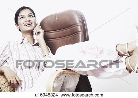 Businesswoman talking on a mobile phone View Large Photo Image Picture - Businesswoman talking on a mobile phone. Fotosearch