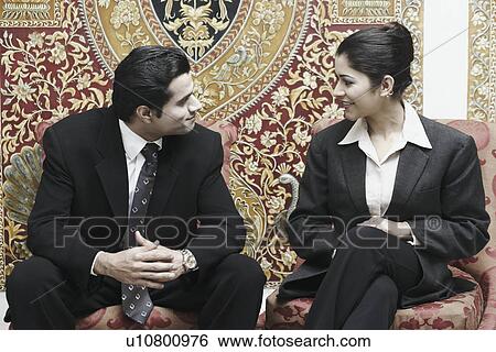 Stock Photograph - Close-up of a businessman and a businesswoman talking. Fotosearch