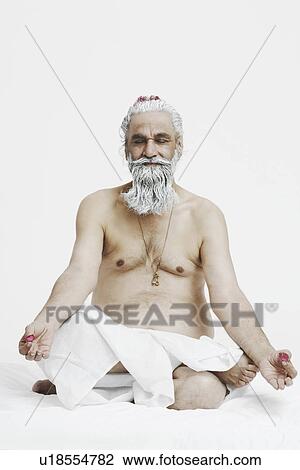 Close-up of a priest sitting in the lotus position View Large Photo Image Stock Image - Close-up of a priest sitting in the lotus position. Fotosearch