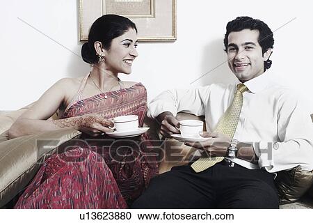 Close-up of a young couple holding cups of tea View Large Photo Image Stock Image - Close-up of a young couple holding cups of tea. Fotosearch