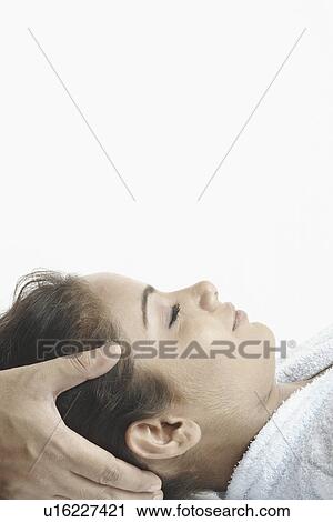 Close-up of a young woman getting a head massage View Large Photo Image Stock Image - Close-up of a young woman getting a head massage. Fotosearch