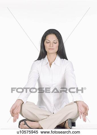 Close-up of a young woman sitting in the lotus position View Large Photo Image Stock Photography - Close-up of a young woman sitting in the lotus position. Fotosearch