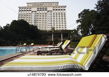 Lounge chairs at the poolside View Large Photo Image Stock Image - Lounge chairs at the poolside. Fotosearch