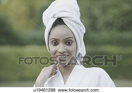 Portrait of a teenage girl smiling with a towel wrapped around her head View Large Photo Image Stock Photo - Portrait of a teenage girl smiling with a towel wrapped around her head. Fotosearch