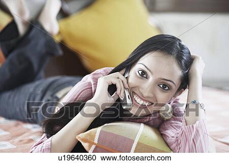 Stock Image - Portrait of a teenage girl talking on a mobile phone. Fotosearch