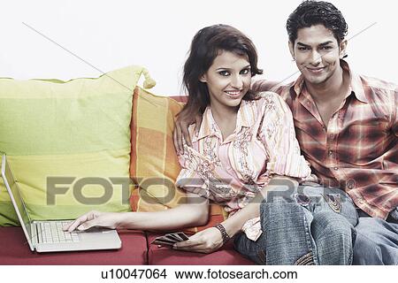 Picture - Portrait of a young couple smiling. Fotosearch