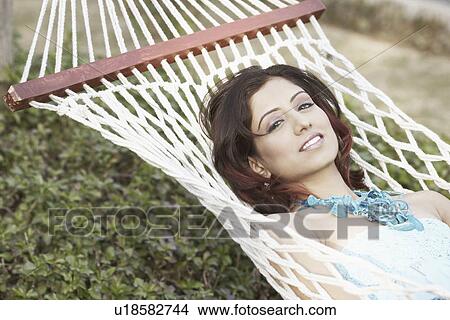 Portrait of a young woman lying in a hammock View Large Photo Image Picture - Portrait of a young woman lying in a hammock. Fotosearch
