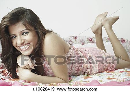Portrait of a young woman smiling View Large Photo Image Stock Photo - Portrait of a young woman smiling. Fotosearch