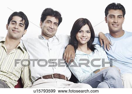 Stock Photo - Portrait of four friends sitting together on a couch. Fotosearch