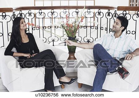 Young man flirting with a young woman View Large Photo Image Stock Photograph - Young man flirting with a young woman. Fotosearch