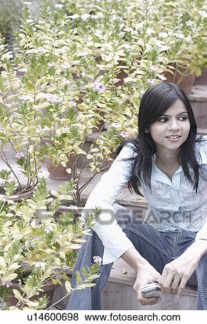 Young woman sitting on steps View Large Photo Image Stock Photo - Young woman sitting on steps. Fotosearch