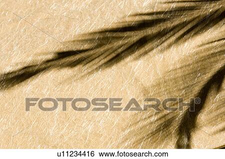 Stock Photograph - Close-up of a shadow on handmade paper. Fotosearch