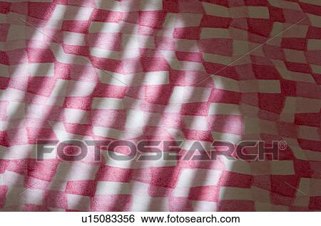 Stock Photograph - Close-up of a shadow on handmade paper. Fotosearch
