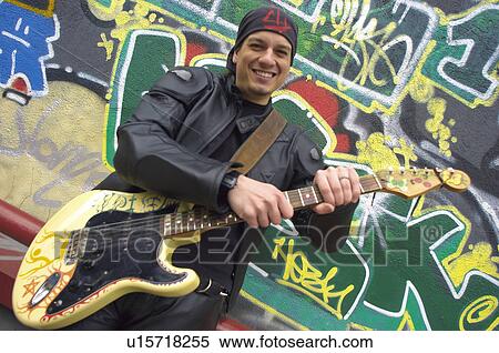 Stock Photography - People, Attitudes, Young Attitudes, Young man, Coat, Black. Fotosearch