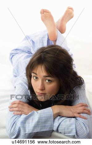 Stock Photograph - Woman, Beauty, Bed, Young, Young woman, Brown hair, Morning. Fotosearch