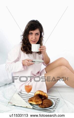 Stock Image - Woman, Breakfast, Having breakfast, Beauty, Young, Young woman, Brown hair. Fotosearch