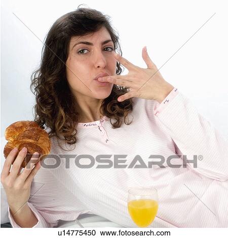 Stock Image - Woman, Breakfast, Having breakfast, Beauty, Young, Young woman, Brown hair. Fotosearch
