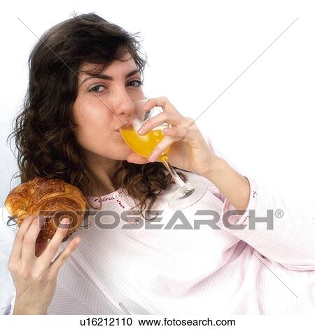 Stock Image - Woman, Breakfast, Having breakfast, Beauty, Young, Young woman, Brown hair. Fotosearch