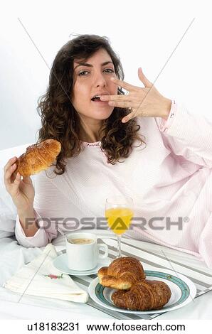 Stock Image - Woman, Breakfast, Having breakfast, Beauty, Young, Young woman, Brown hair. Fotosearch