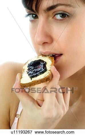 Stock Photo - Woman, Breakfast, Having breakfast, Beauty, Young, Young woman, Morning. Fotosearch