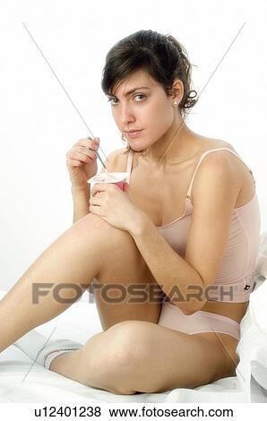 Stock Photo - Woman, Breakfast, Having breakfast, Beauty, Young, Young woman, Morning. Fotosearch